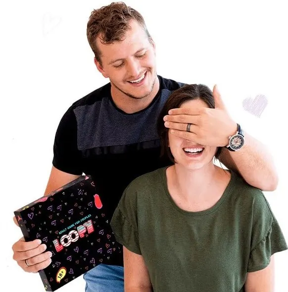 Man covers his smiling partner's eyes with one hand and holds the Loopy box in the other